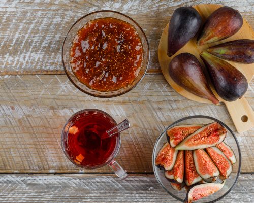 3figs-with-tea-fig-jam-teaspoon-bowl-wooden-cutting-board-flat-lay